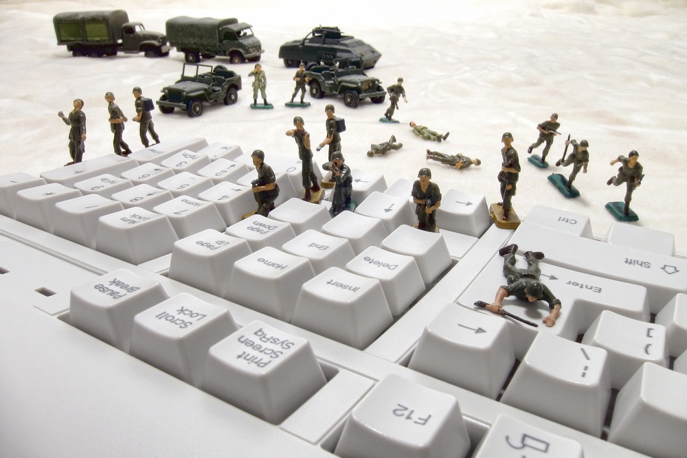 Toy soliders fighting on a keyboard
